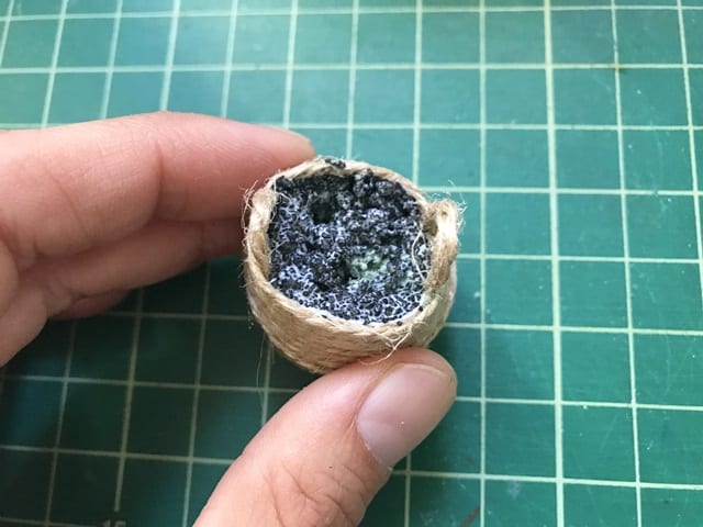 miniature belly basket with floral foam, topped with granule and glue mixture