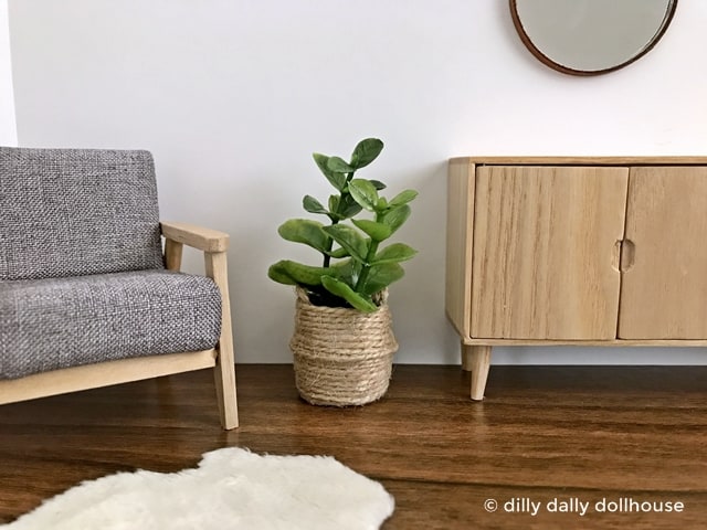 miniature fiddle leaf fig in belly basket planter held by hand