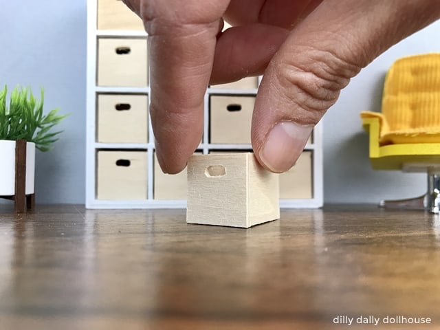 miniature wooden box held by hand