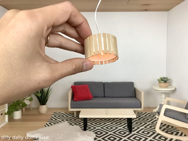 miniature ceiling light held by hand