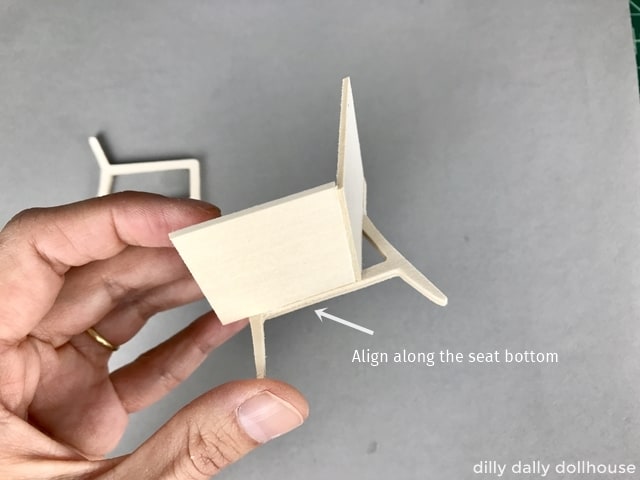 bottom of seat attached to chair side