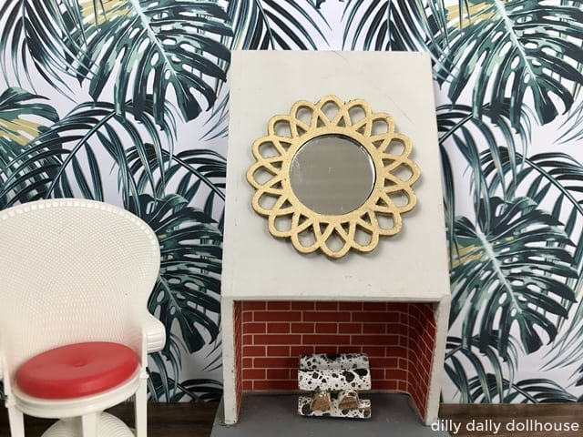 miniature gold starburst mirror on a fireplace in a dollhouse 1:16 scene