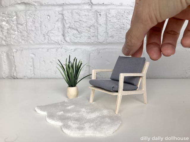 modern dollhouse chair held by hand