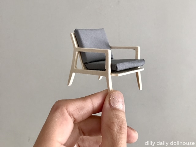 finished modern miniature chair held by hand