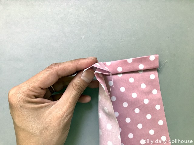 cute fabric folded to start a dollhouse blanket