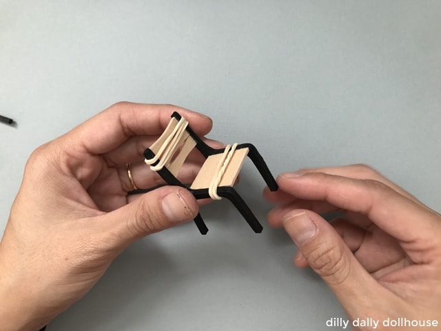 dollhouse chair secured with rubber bands