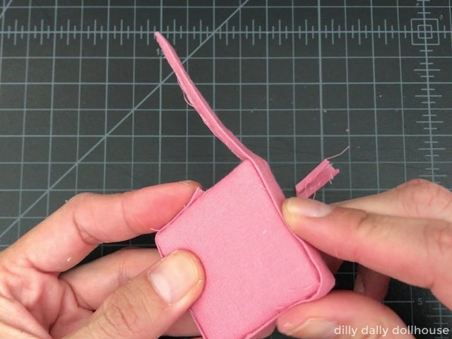 Wrap the edges of foam core with a strip of fabric.  Snip off excess fabric and neaten the ends.