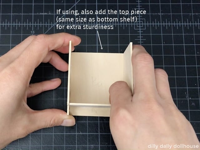 attaching the bottom shelf of the dollhouse kitchen cabinet