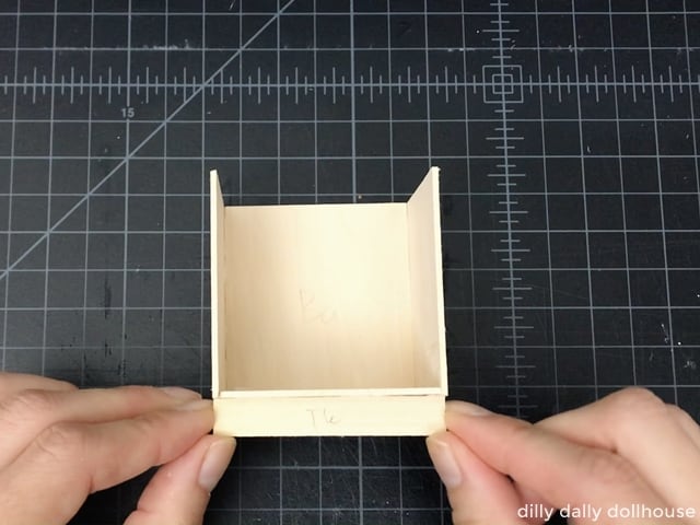 attach the toekick to the bottom of the dollhouse kitchen cabinet