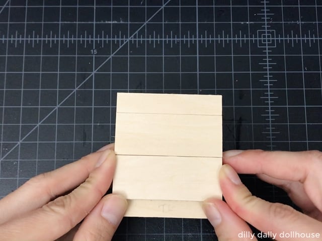 attach the fake drawers of the dollhouse kitchen cabinet