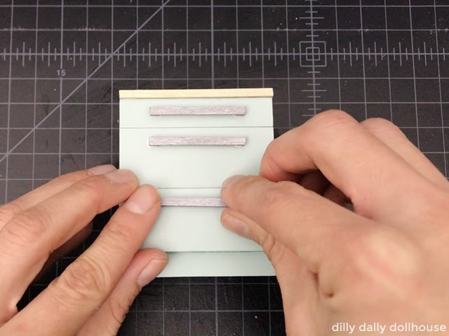attaching the handles to the drawer fronts