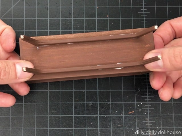 Legs are attached to the bottom of the credenza