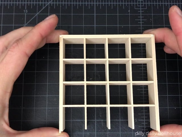 assembling the outer frame and grids of miniature cube shelves