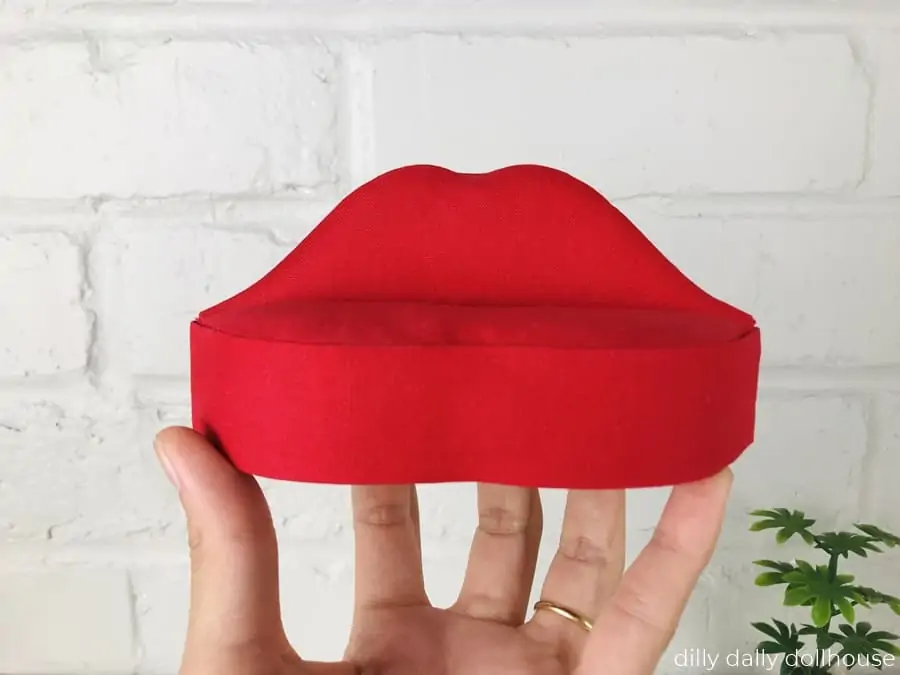 miniature lips sofa held by hand